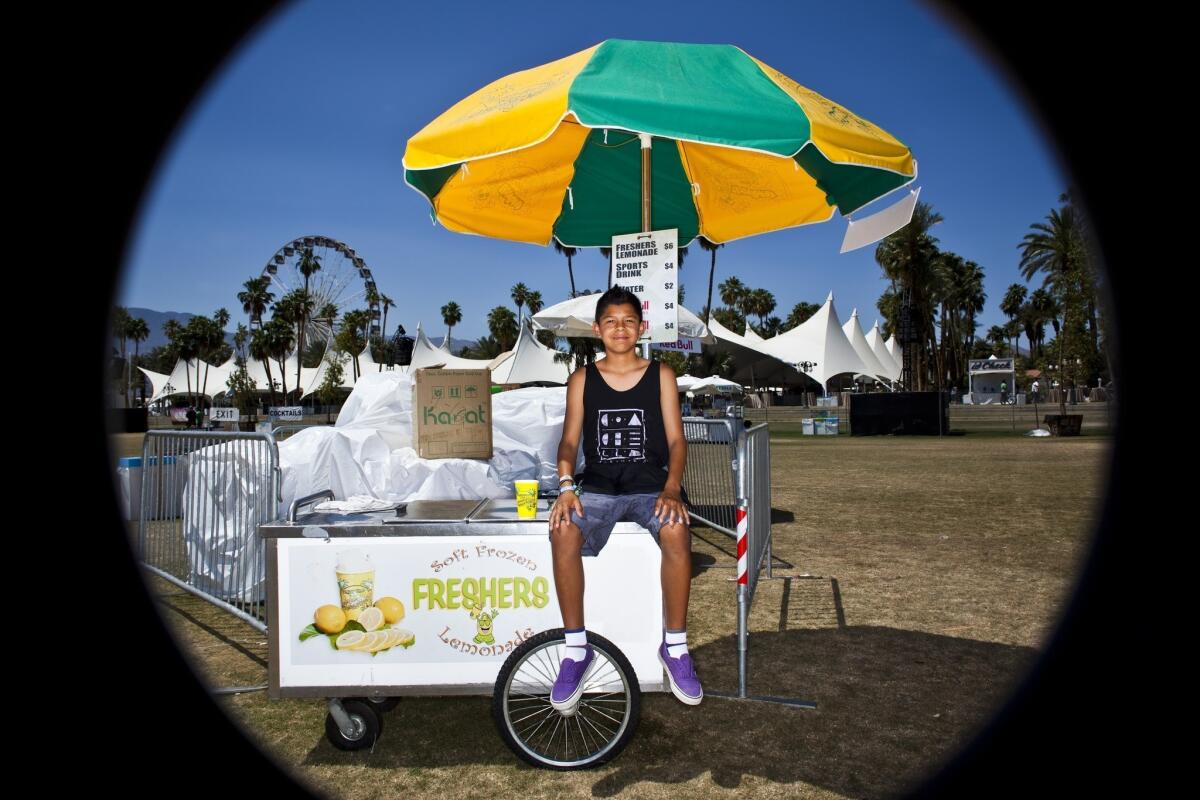 Adrian Lopez, 12, from Palm Springs helped his dad, Steve, out with frozen lemonade and water last year during his first Coachella festival.