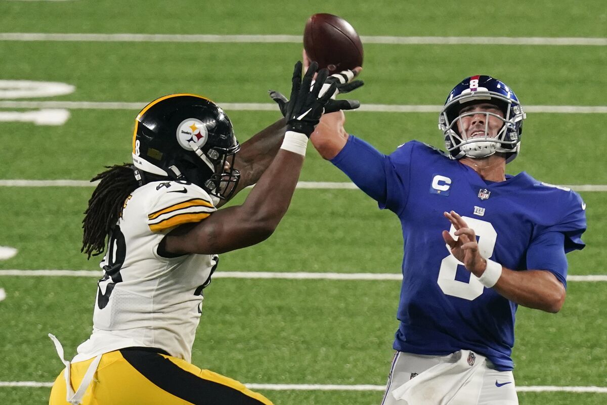 New York Giants quarterback Daniel Jones (8) throws under pressure from Pittsburgh Steelers outside linebacker Bud Dupree (48) during the third quarter of an NFL football game Monday, Sept. 14, 2020, in East Rutherford, N.J. (AP Photo/Seth Wenig)