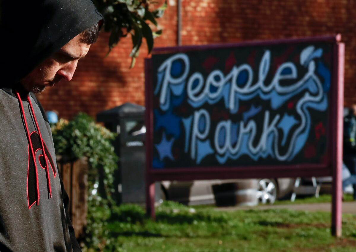 A man in front of a sign that says People's Park