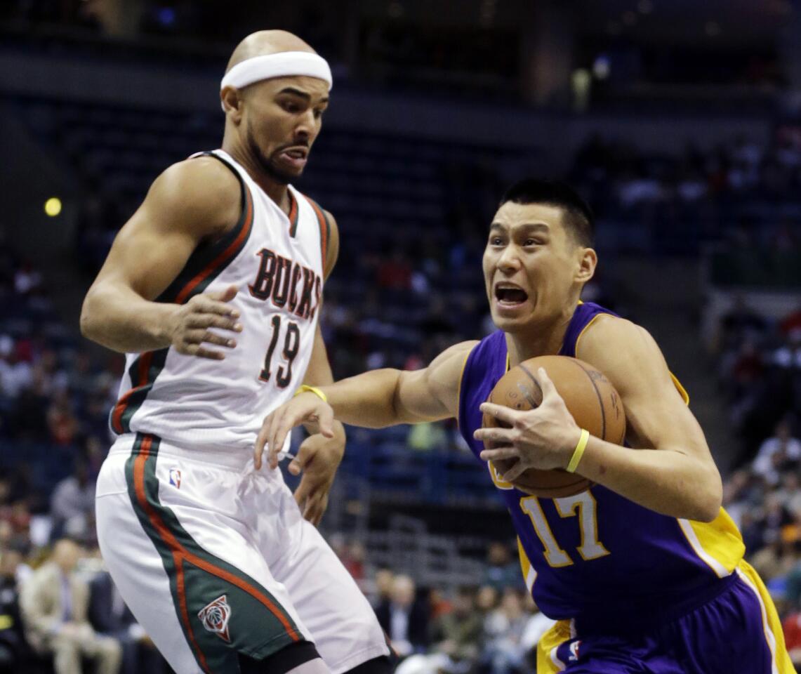 Jeremy Lin drives against Bucks guard Jerryd Bayless during the first half of a game in Milwaukee.