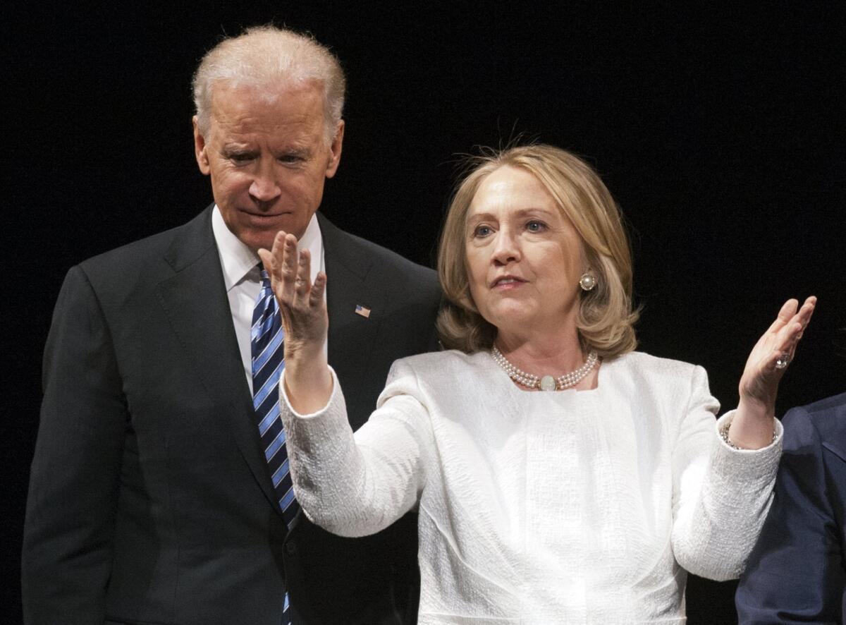 In this April 2, 2013 photo, Vice President Joe Biden and Hillary Rodham Clinton appear onstage together at an awards event in Washington.