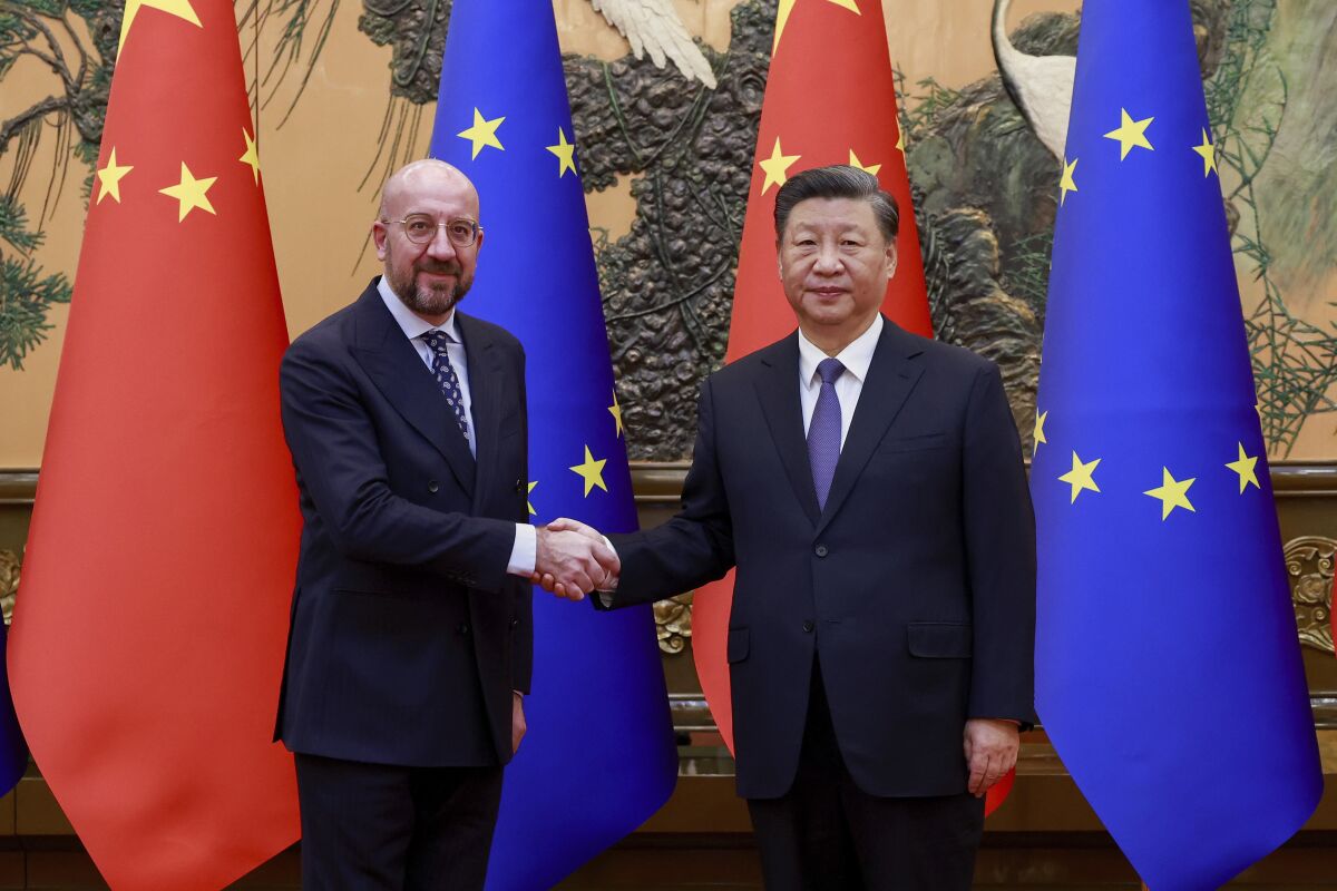 In this photo released by Xinhua News Agency, Chinese President Xi Jinping, right, shakes hands with European Council President Charles Michel before their meeting at the Great Hall of the People in Beijing, Thursday, Dec. 1, 2022. (Ding Lin/Xinhua via AP)