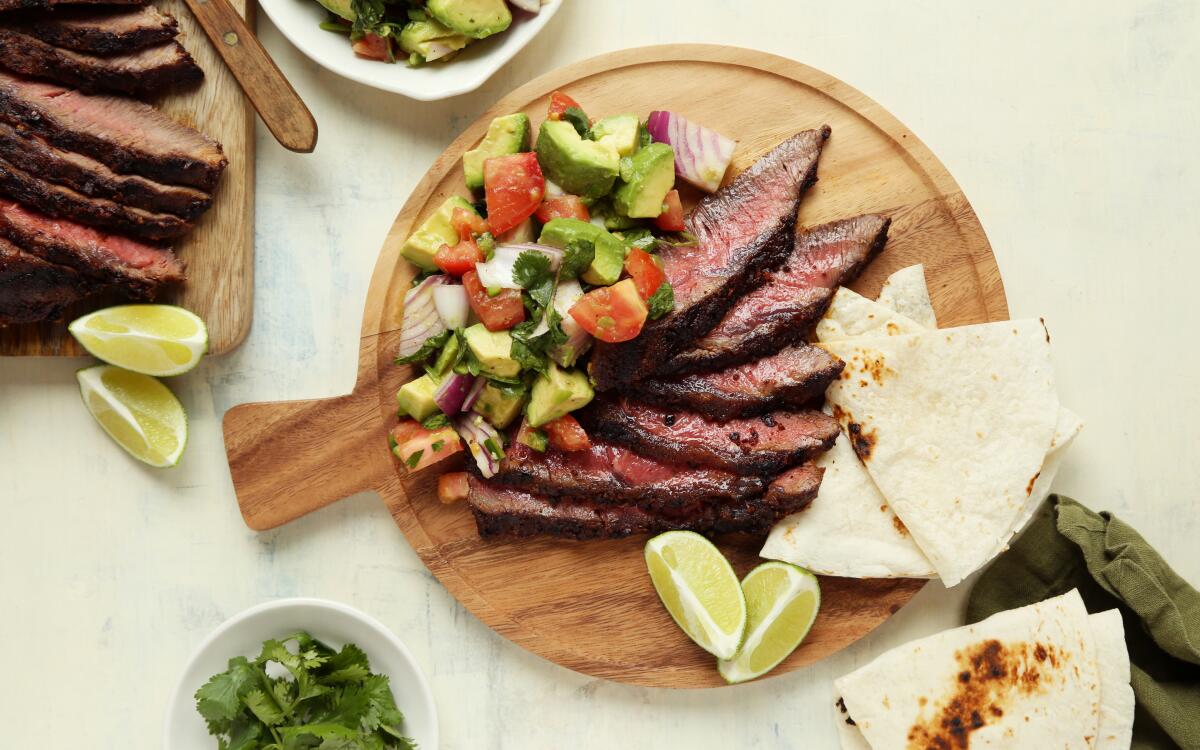 Large chunks of avocado and veggies act as a salad to super-flavorful steak seasoned with taco spices.