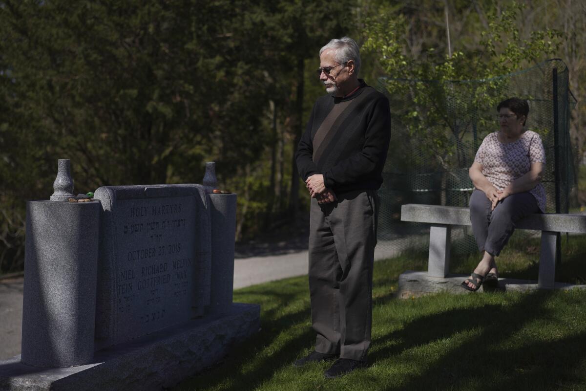 Co-presidents of New Light Congregation, Stephen Cohen and Barbara Caplan, visit a memorial in the New Light Cemetery.