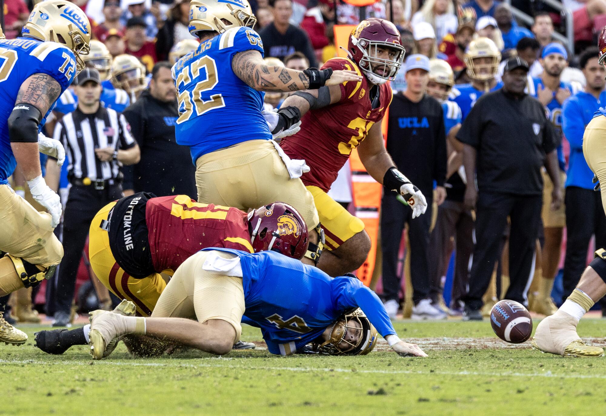 USC defensive end Solomon Byrd forces UCLA quarterback Ethan Garbers to fumble Saturday at the Coliseum.