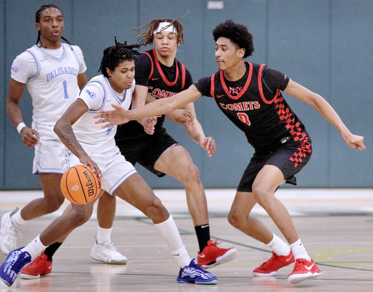 Tajh Ariza of Westchester tries to steal the ball from Palisades' Tommy Pickens.