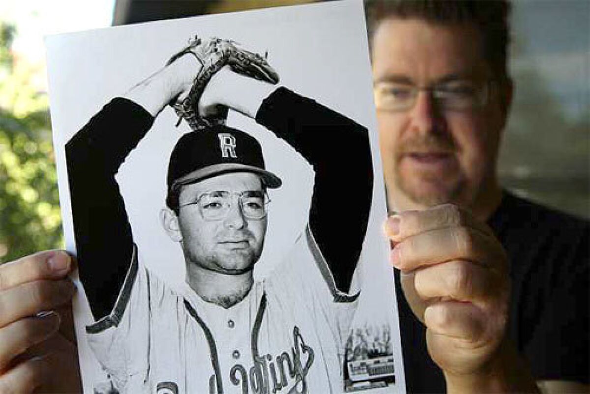 Baseball historian Terry Cannon holds a photo of Steve Dalkowski, a minor leaguer who is believed by some to have thrown the fastest pitch in history.