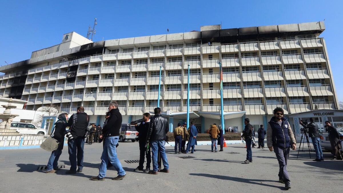 Journalists gather Jan. 23 outside the Intercontinental Hotel in Kabul, Afghanistan, after a deadly attack by militants.