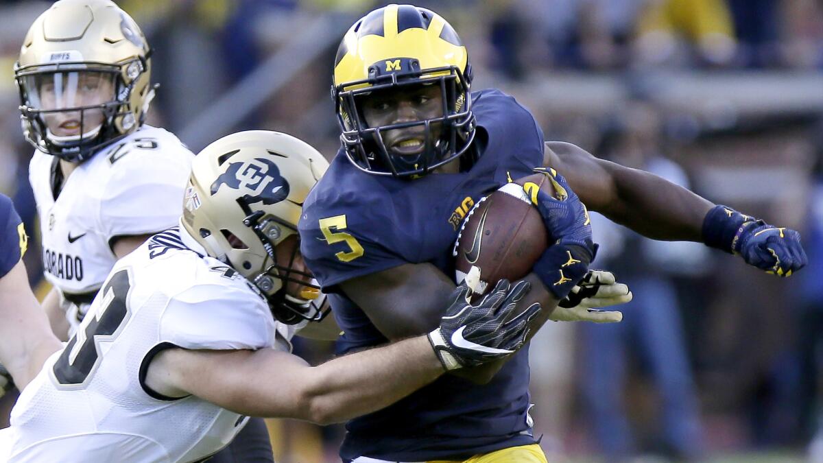 Michigan linebacker Jabrill Peppers breaks a tackle on the way to a 54-yard punt return touchdown Saturday against Colorado.