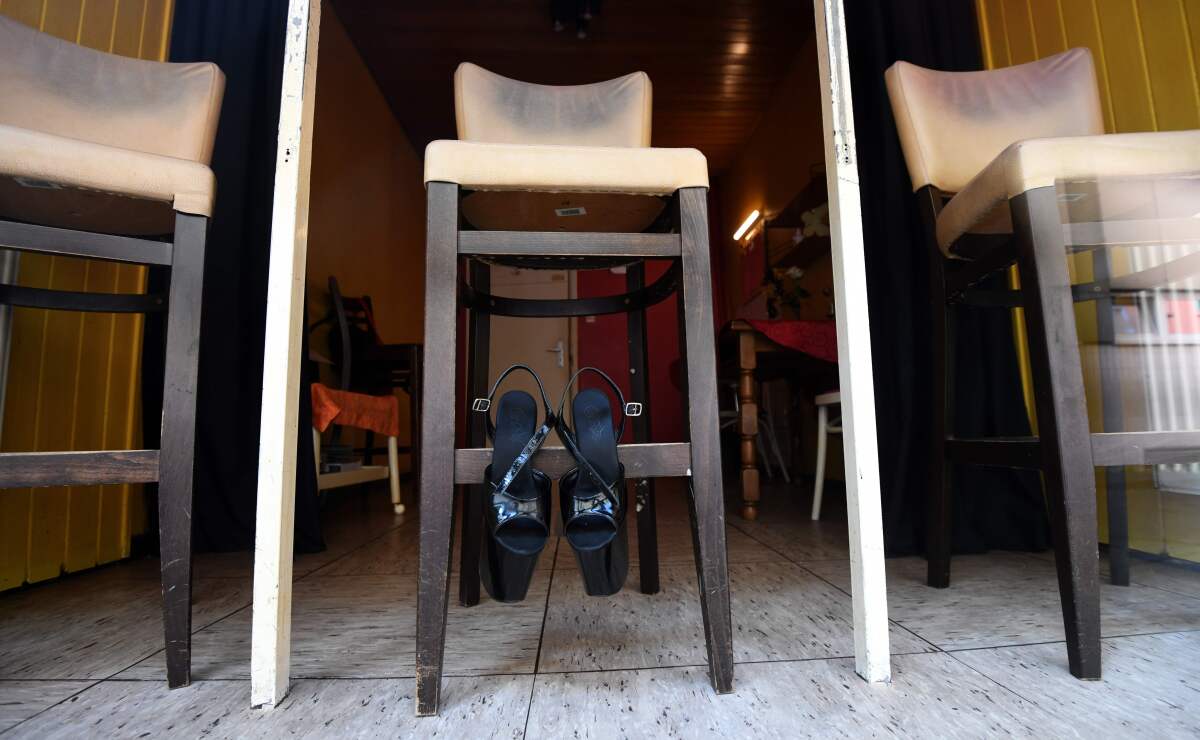 Shoes hang on a bar stool in a closed brothel in Dortmund, Germany, where many activities came to a halt due to the coronavirus.