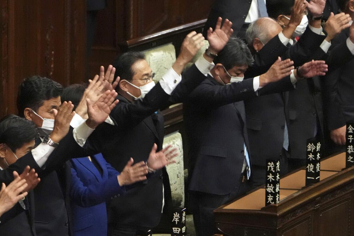 Japanese Prime Minister Fumio Kishida and other lawmakers applauding