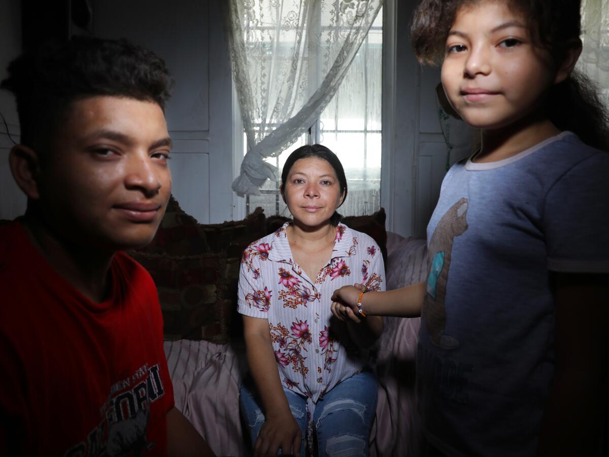 Lucy, center, is photographed with her son Anner, 18, left, and daughter Mariela, 10, 