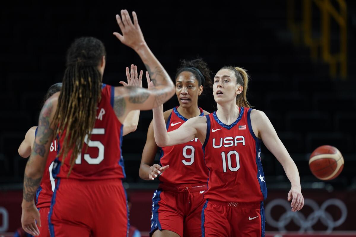 United States's Breanna Stewart (10) high-fives with teammates during a game against Australia at the Tokyo Olympics