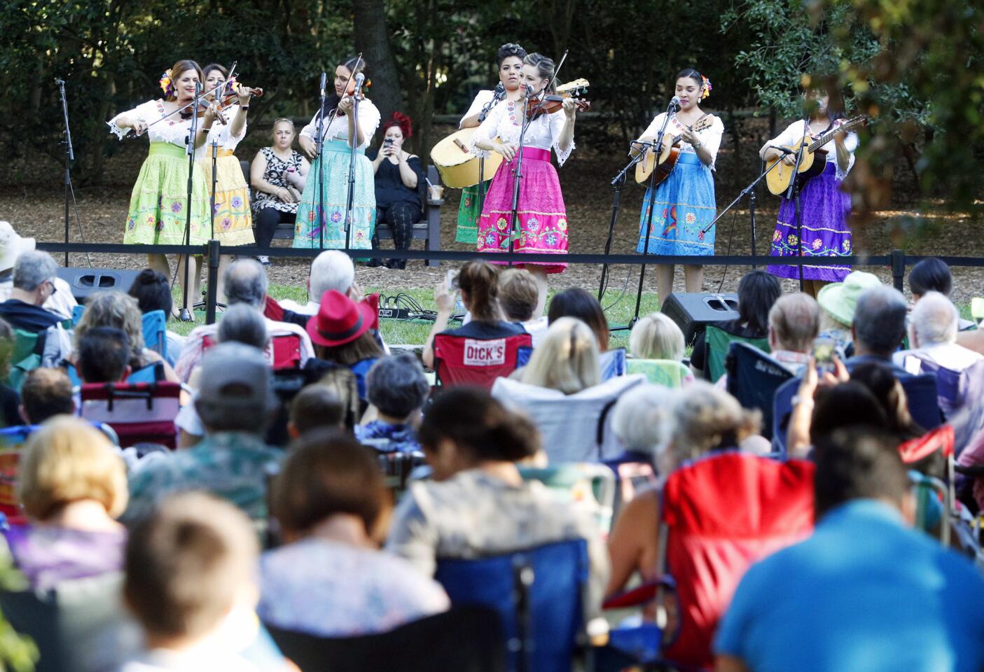 The all-female mariachi band, of Los Angeles, The Hummingbirds, begin their performance for a crowd on the main lawn at Descanso Gardens for their World Rhythms series on Tuesday, June 26, 2018. This is a six-week series of music and dance performances is one of a few other summer activities intended on drawing people into the gardens during the longer summer days and cooler evening temperatures.
