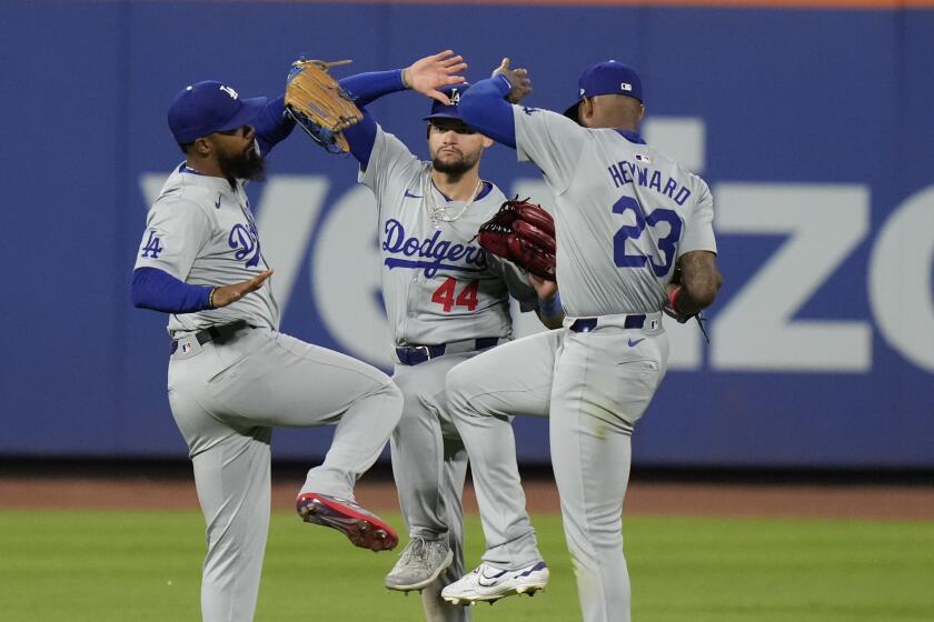 Los Angeles Dodgers' Teoscar Hernández, left, Andy Pages, center, and Jason Heyward celebrate after the second baseball game of a doubleheader against the New York Mets, Tuesday, May 28, 2024, in New York. The Dodgers won 3-0. (AP Photo/Frank Franklin II)
