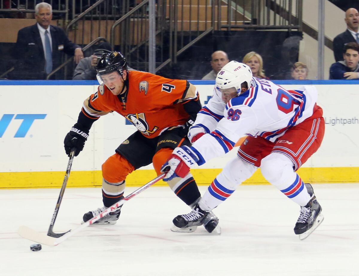 Ducks defenseman Cam Fowler (4) tries to hold off Emerson Etem (96) of the Rangers as he pursues the puck during a game on Dec. 22, 2015.