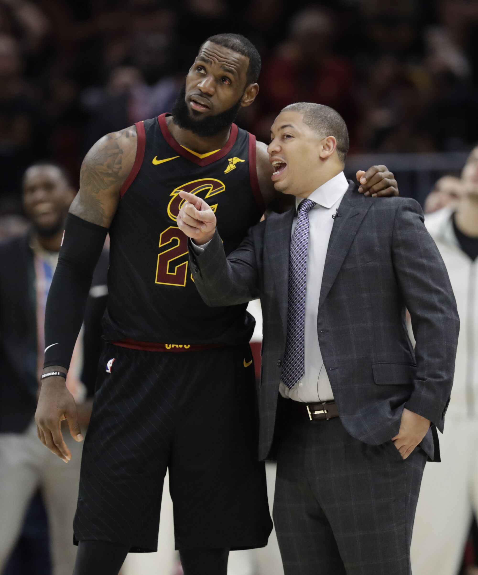 Tyronn Lue talks with Cavaliers star LeBron James during an NBA Final game in 2016.
