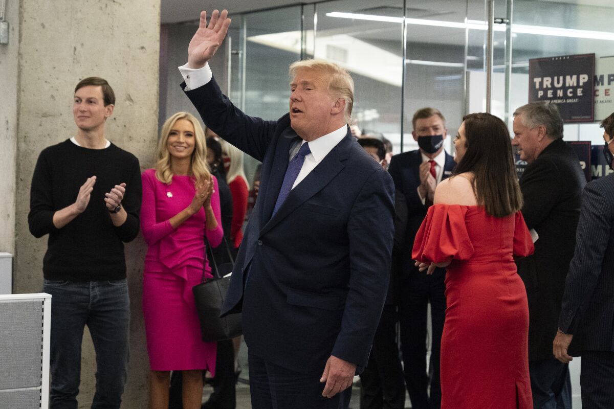 President Trump waves after speaking at the Trump campaign headquarters on election day.