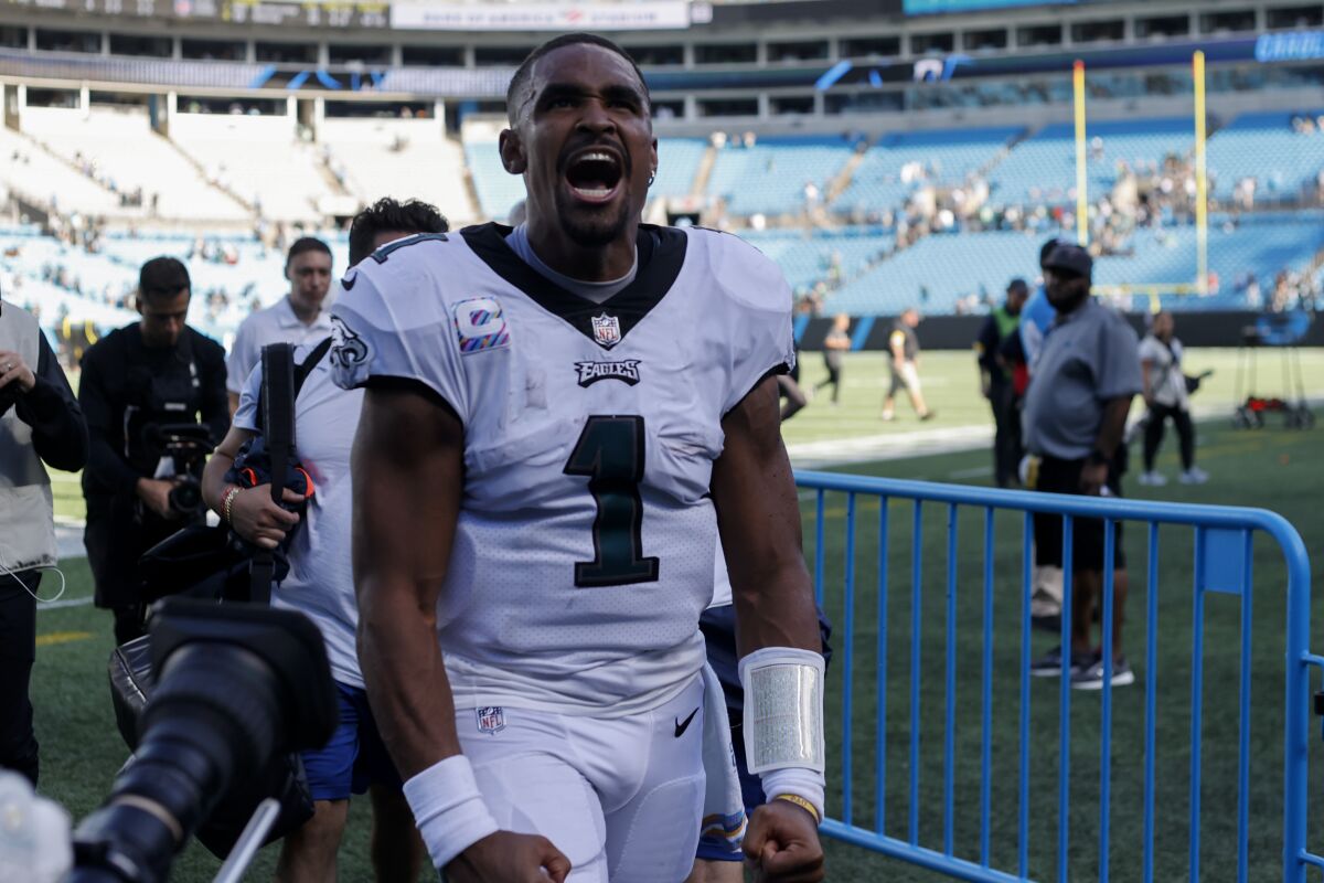 Philadelphia Eagles quarterback Jalen Hurts celebrates their win against the Carolina Panthers in an NFL football game Sunday, Oct. 10, 2021, in Charlotte, N.C. (AP Photo/Nell Redmond)