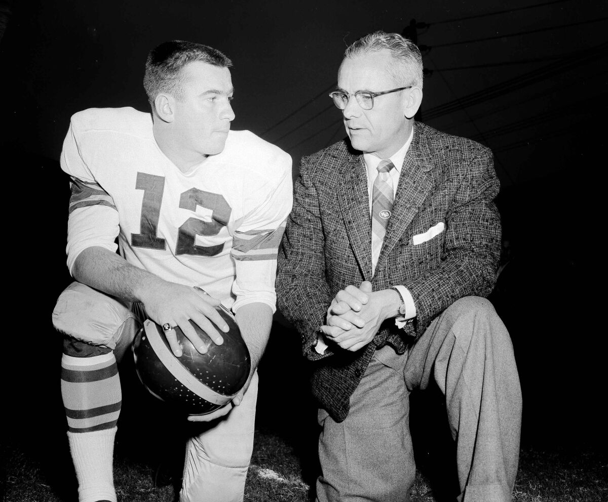 USC coach Jess Hill, right, talks with star quarterback Jim Contratto in 1954. (AP Photo)