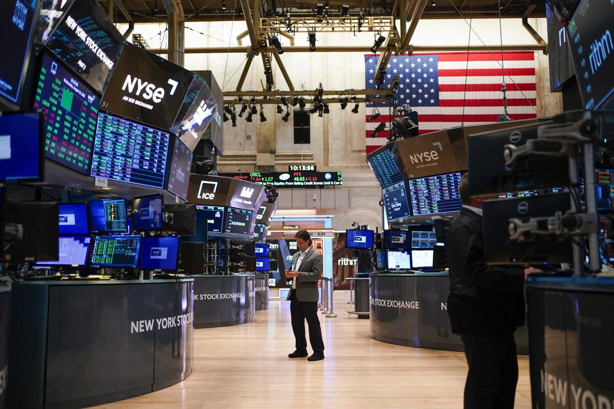 Traders work on the floor at the New York Stock Exchange 