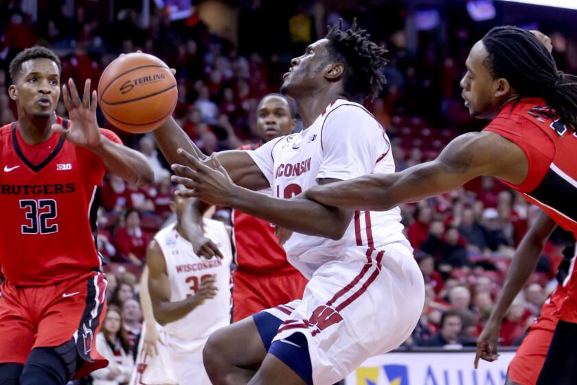 Rutgers' Deshawn Freeman, right, fouls Wisconsin's Nigel Hayes during the second half Tuesday.