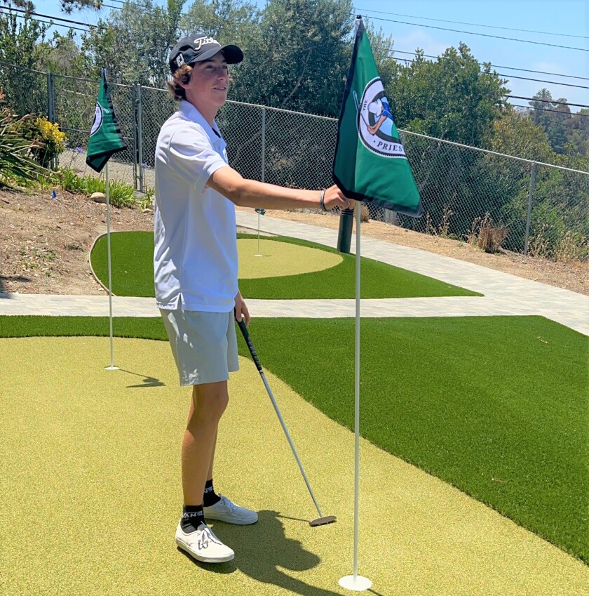 Priest James Rivera, 16, on the new putting green he designed at UCSD Health's Bannister Family House for long-term patients.