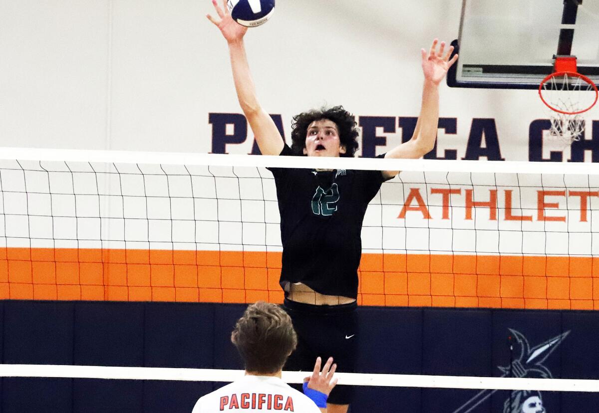 Sage Hill's Jackson Cryst (12) blocks the ball against Pacifica Christian in a nonleague boys' volleyball match on Friday.