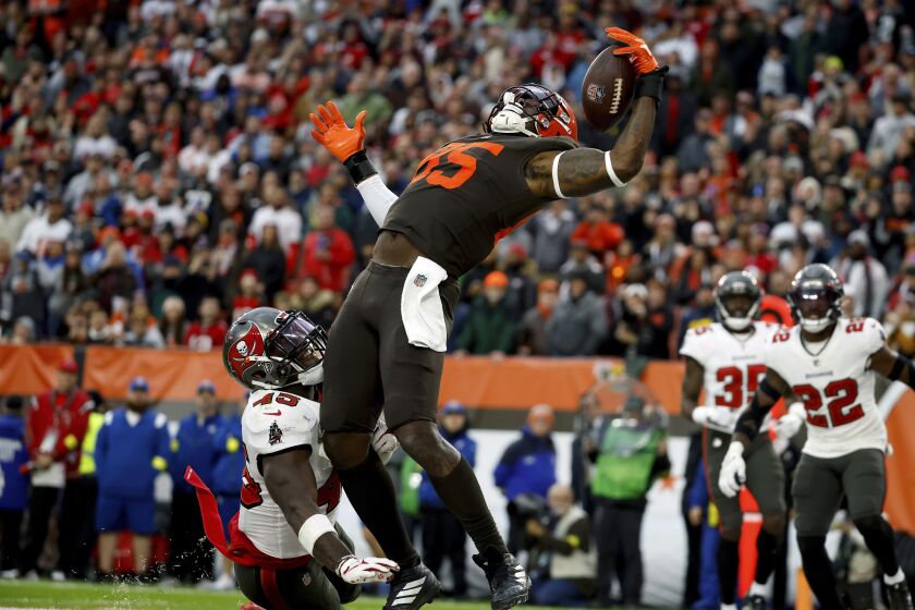 Cleveland Browns tight end David Njoku (85) catches a pass for a touchdown during an NFL football game against the Tampa Bay Buccaneers, Sunday, Nov. 27, 2022, in Cleveland. Njoku will miss Sunday's game against Houston with a knee injury, keeping one of Cleveland's offensive targets off the field for Deshaun Watson's return. (AP Photo/Kirk Irwin)