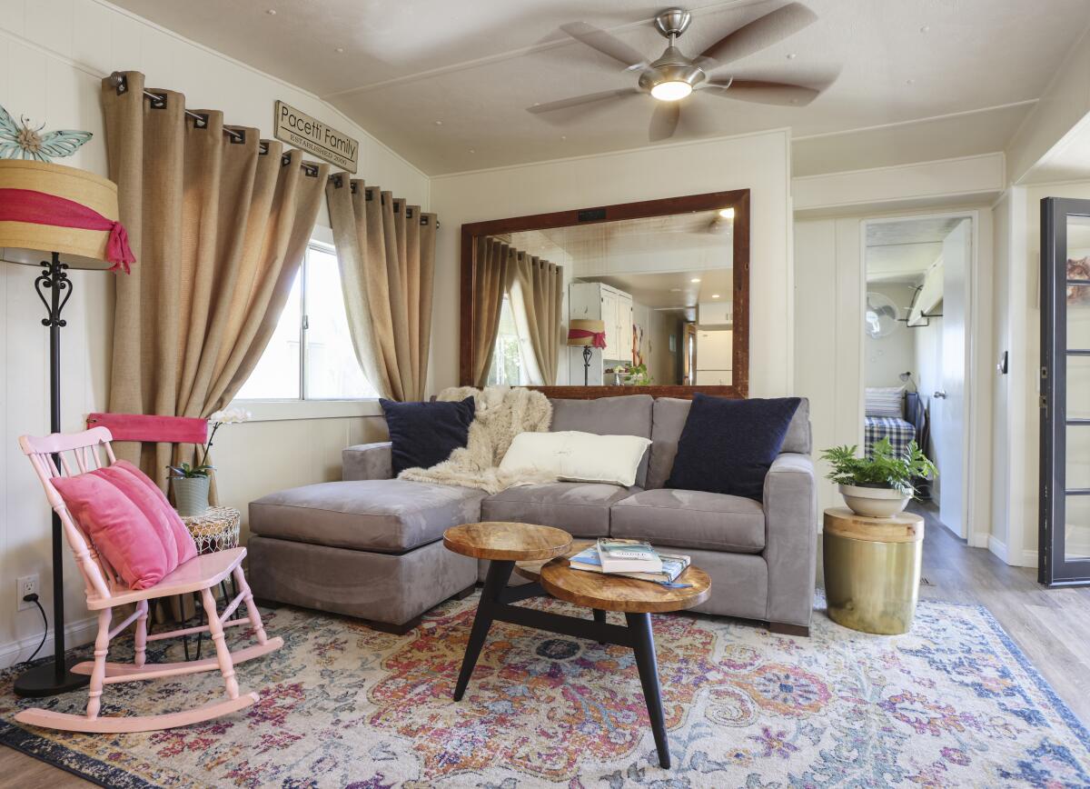 A blend of vivid colors in the Pacettis’ living room plays off the Oriental-style rug in the home in Carlsbad.