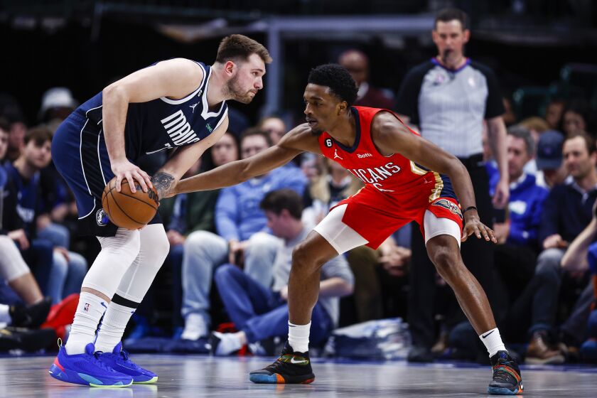 Dallas Mavericks guard Luka Doncic, left, looks for room against New Orleans Pelicans forward Herbert Jones, right, during the first half of an NBA basketball game, Thursday, Feb. 2, 2023, in Dallas. (AP Photo/Brandon Wade)
