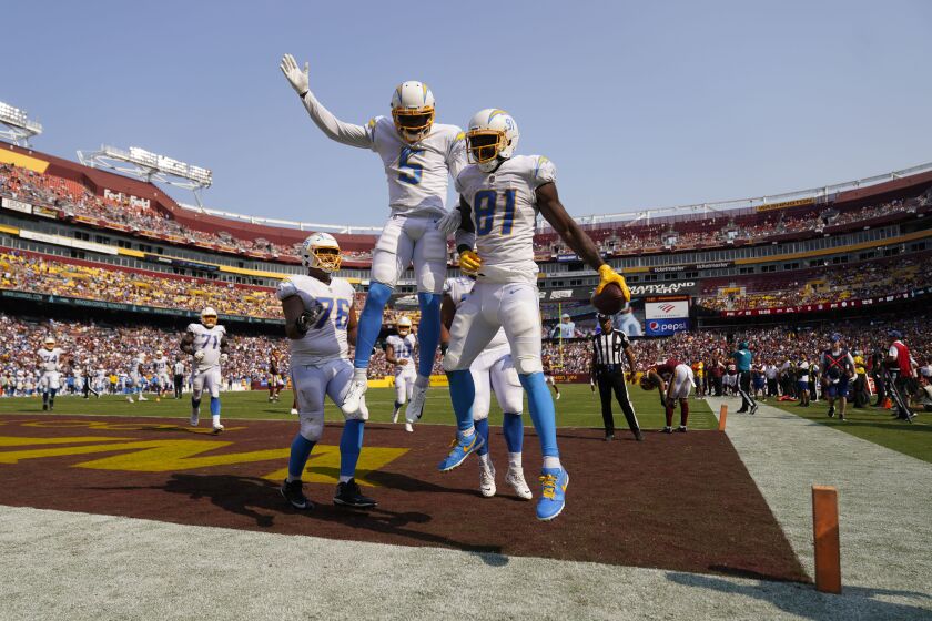 Los Angeles Chargers wide receiver Mike Williams (81) celebrates his touchdown with teammate wide receiver Josh Palmer (5) during the second half of an NFL football game against Washington Football Team, Sunday, Sept. 12, 2021, in Landover, Md. Chargers won 20-16. (AP Photo/Andrew Harnik)