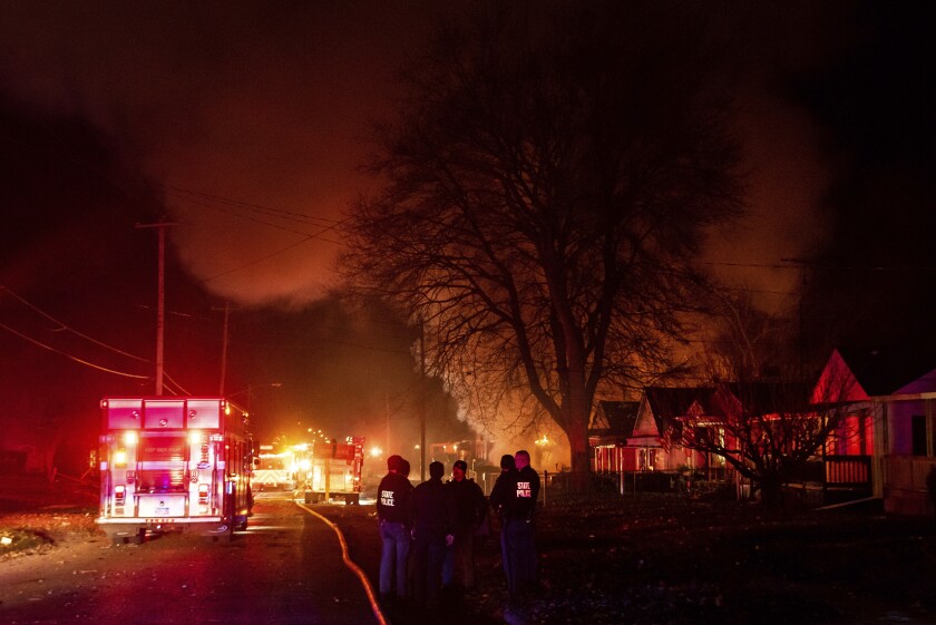 Emergency personnel are shown at the scene of a fire and explosion at a home in Flint, Mich., Monday night, Nov. 22, 2021. Three people were missing following the fire and explosion, authorities said. (Isaac RitcheyThe Flint Journal via AP)