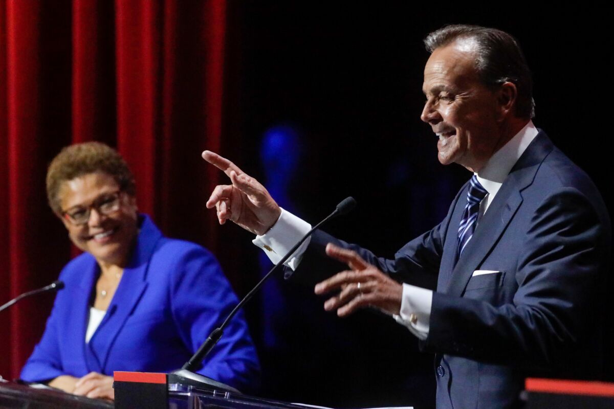 U.S. Rep. Karen Bass smiles at a point made by businessman Rick Caruso during a mayoral debate