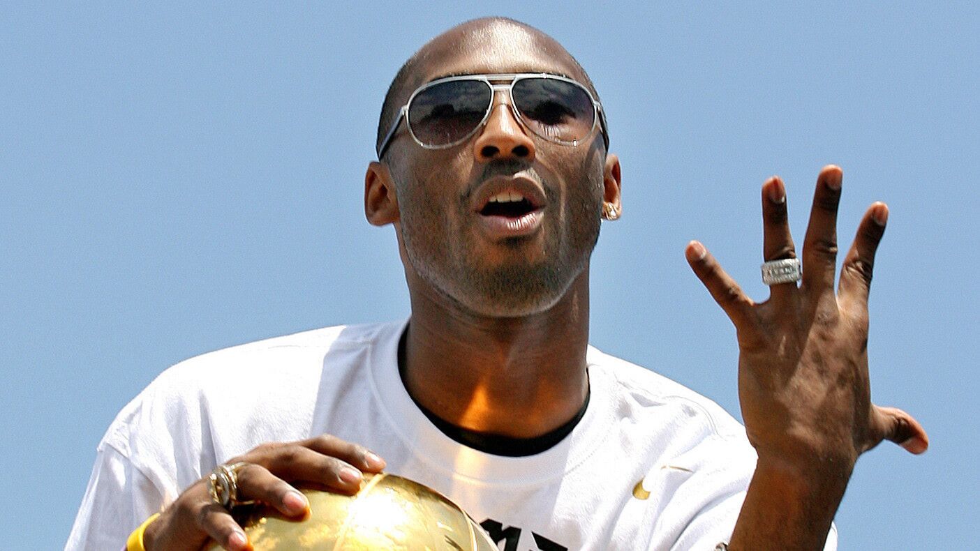 Kobe Bryant gestures while celebrating his fifth championship with the Lakers during a team parade in Los Angeles on June 21, 2010.
