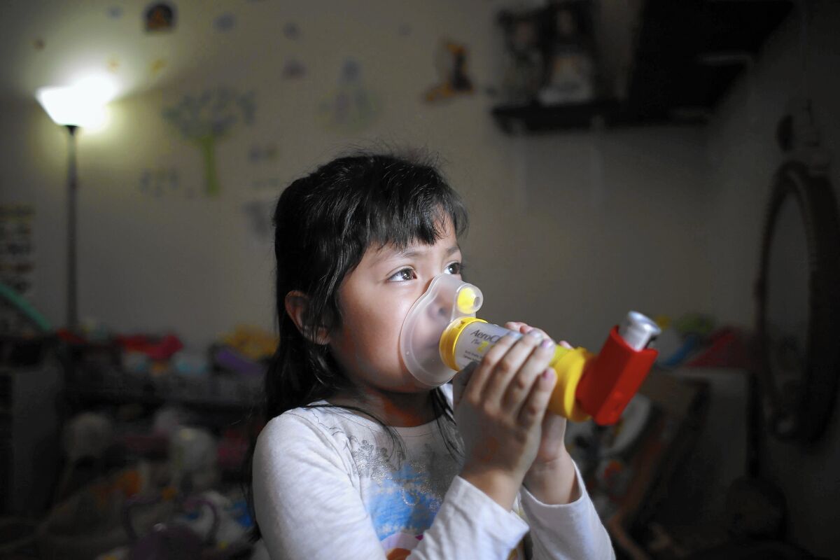 Four-year-old Alani Hernandez, whose family lives in Fontana, is so used to the variety of devices she uses for her asthma that she refers to them as if they were toys. She calls this one a teddy bear.