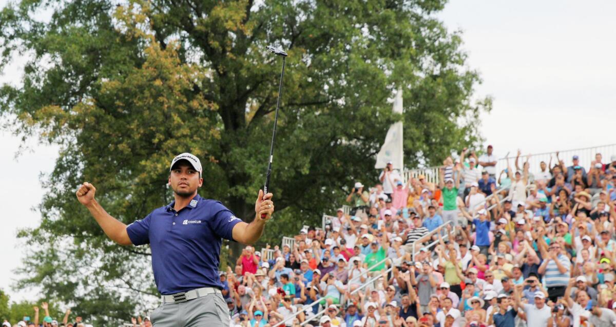 Jason Day of Australia celebrates on the 18th green after his six-stroke victory at The Barclays at Plainfield Country Club on Aug. 30.
