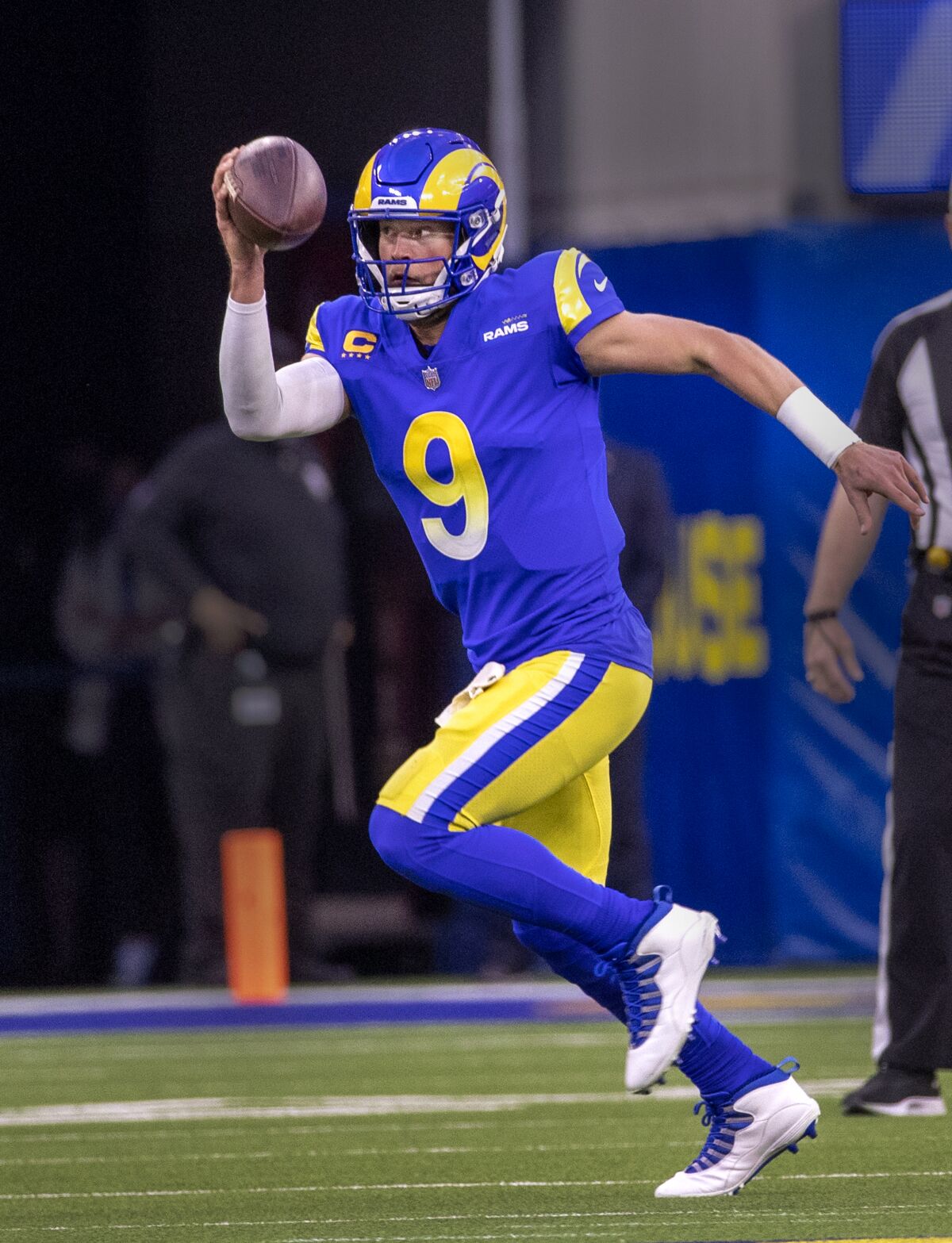 Rams quarterback Matthew Stafford prepares to throw while on the run.