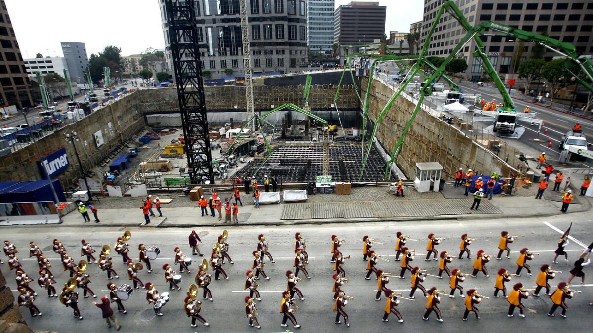 The USC marching band leads a parade on Figueroa Street in downtown Los Angeles to kick off what became the world's largest continuous concrete pour.