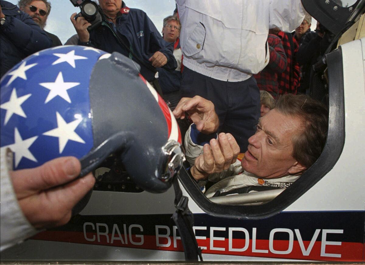  Craig Breedlove reaches for his helmet prior to making his first test run in his car "Spirit of America" on Oct 23, 1996.
