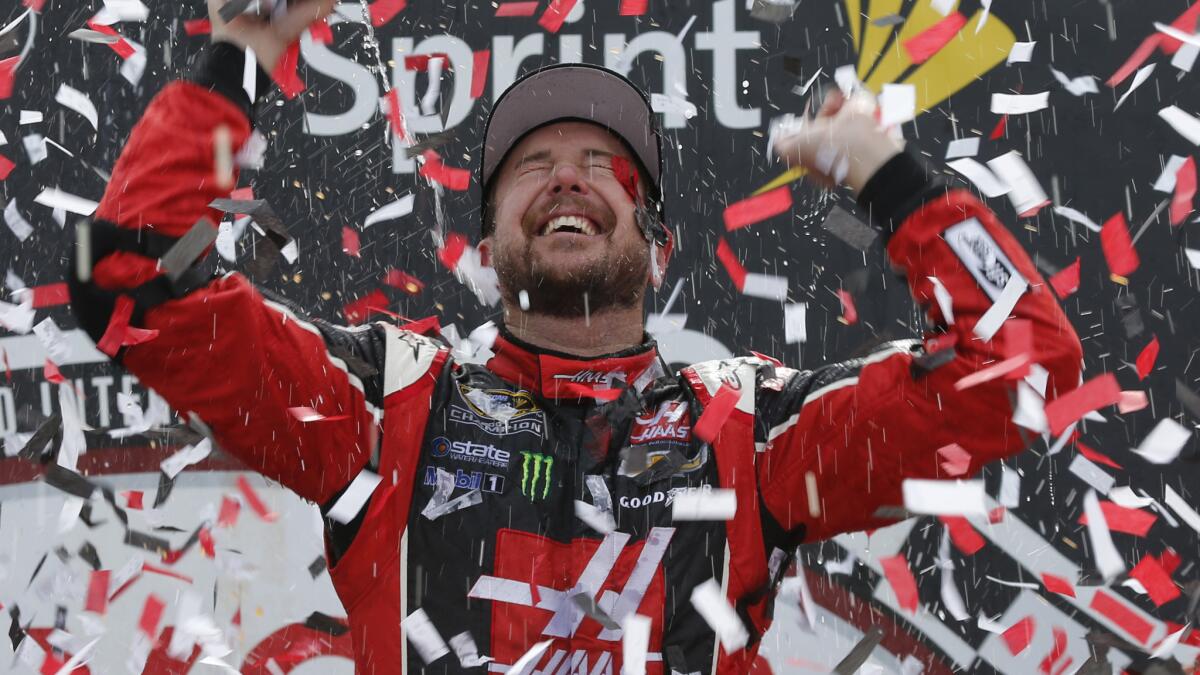 Kurt Busch celebrates after winning Sunday's NASCAR Sprint Cup race at Richmond International Raceway.