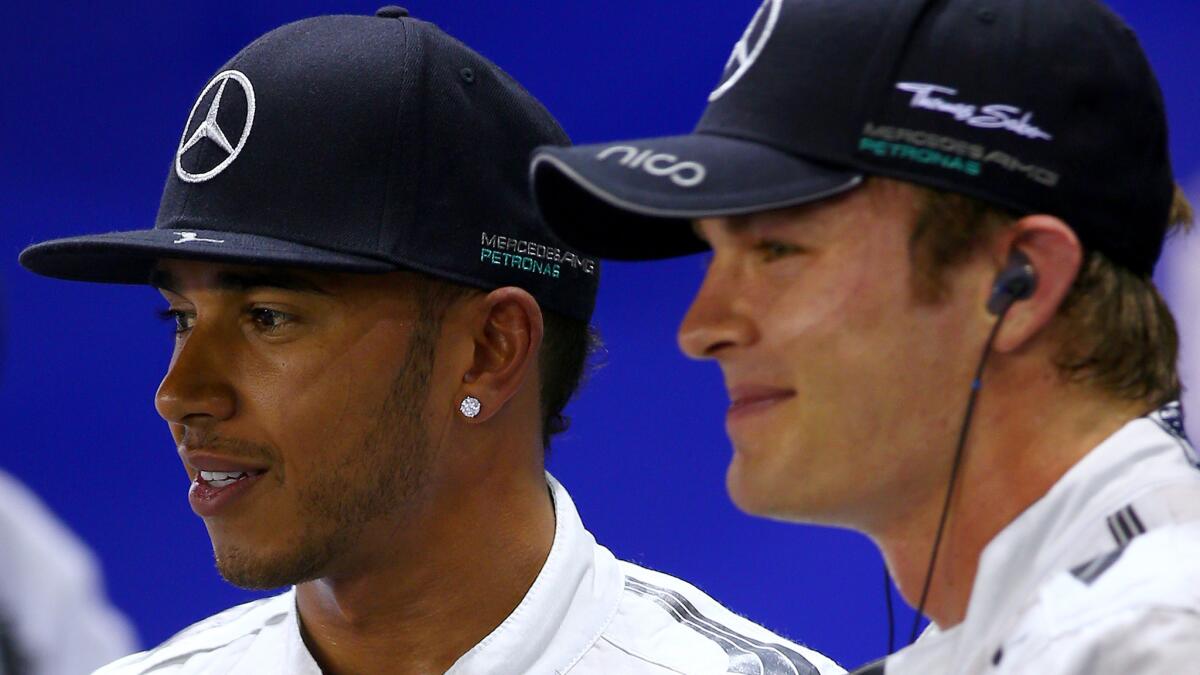 Mercedes teammates Lewis Hamilton, left, and Nico Rosberg look on after qualifying for the Grand Prix of Singapore on Saturday.