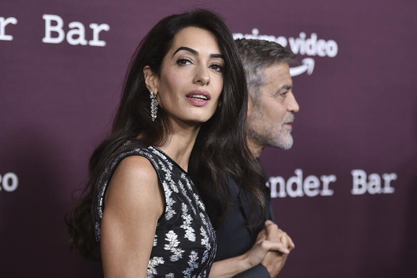 FILE - Amal Clooney, left, and George Clooney arrive at a screening of "The Tender Bar," Oct. 3, 2021, at the Directors Guild of America in Los Angeles. Amal Clooney is one of the legal experts who recommended that the world's top war crimes court seek arrest warrants for Israeli Prime Minister Benjamin Netanyahu and leaders of the militant Hamas group, Clooney announced Monday, May 20, 2024. (Photo by Richard Shotwell/Invision/AP, File)