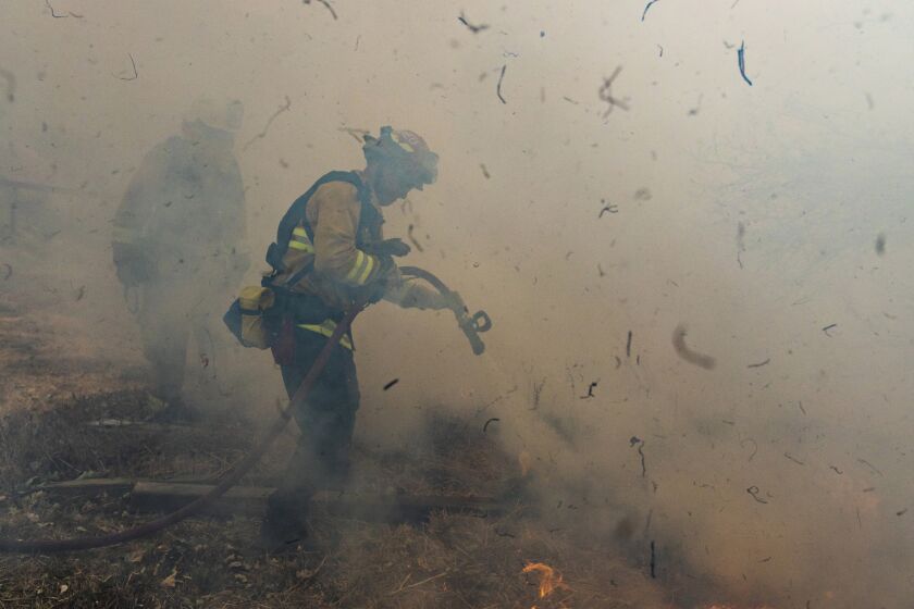 Firefighters from San Matteo battle the Kincade fire in Sonoma County on Sunday.