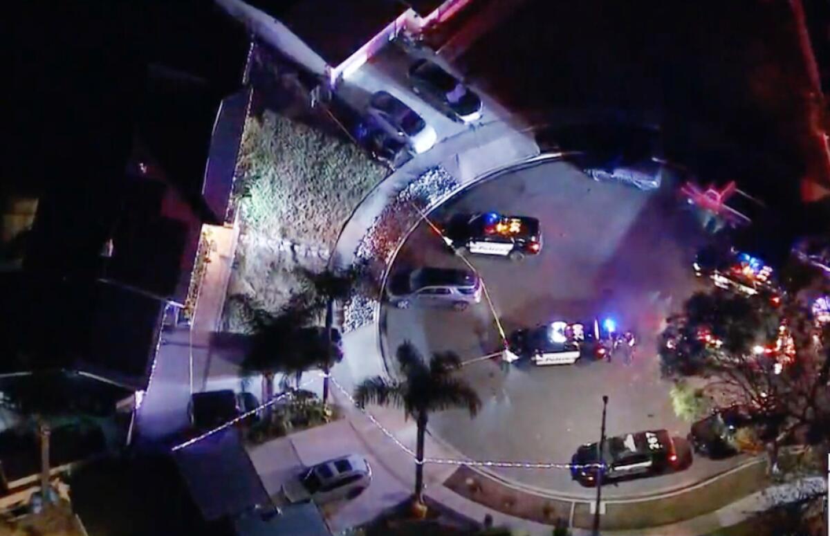 An aerial view of law enforcement vehicles parked in a cul-de-sac