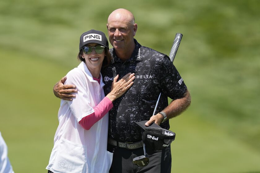 Stewart Cink hugs his wife and caddie, Lisa, after the first round of the Memorial golf tournament, Thursday, June 1, 2023, in Dublin, Ohio. (AP Photo/Darron Cummings)