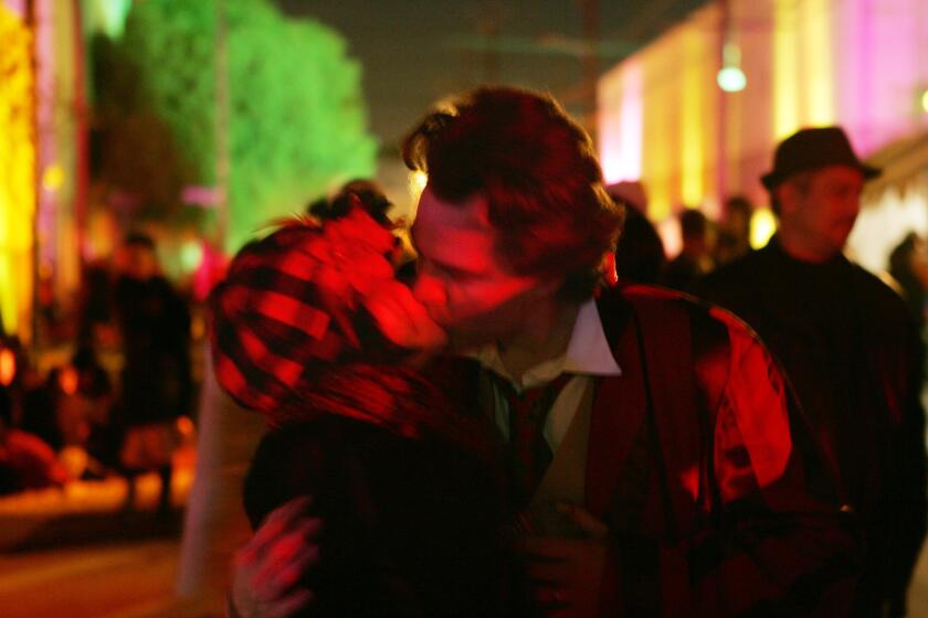 A couple shares a spontaneous moment of love in the street during the Lucent L' Amour street festival held the night of Valentine's Day in downtown Los Angeles on Feb. 15, 2009.