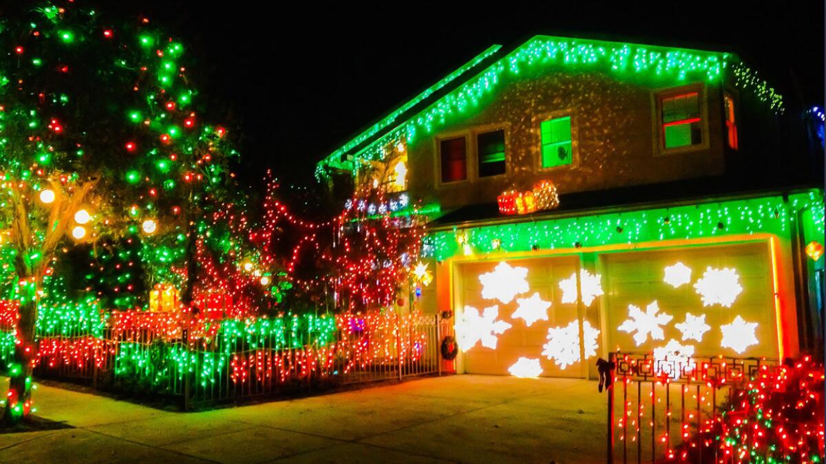 A Santa Monica home is decorated for the holidays with traditional lights and some computer-sequenced lasers on Dec. 8.