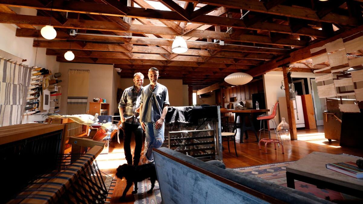 Designers Sean Dougall, left, and Andrew Paulson stand in the middle of their live-work studio in Watts. Working in a former light bulb factory, the couple design furniture, ceramics, and weavings for Dougall Paulson.