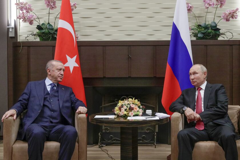 FILE - Russian President Vladimir Putin, right, and Turkish President Recep Tayyip Erdogan talk to each other during their meeting in the Bocharov Ruchei residence in the Black Sea resort of Sochi, Russia, on Sept. 29, 2021. Putin's visit to Iran starting Tuesday is intended to deepen ties with regional heavyweights as part of Moscow's challenge to the United States and Europe amid its grinding campaign in Ukraine. (Vladimir Smirnov, Sputnik, Kremlin Pool Photo via AP, File)